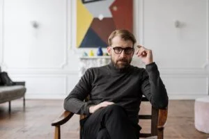 A male therapist sitting on a chair