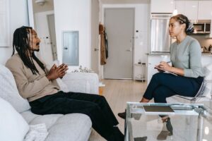 A man in a one to one therapy session at rehab