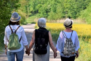 A mother and her two daughters walking together during a visit at drug and alcohol rehab in Bedfordshire