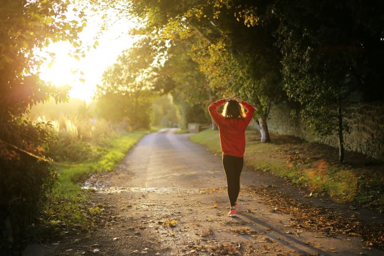 A woman taking a mental health walk in recovery from alcoholism