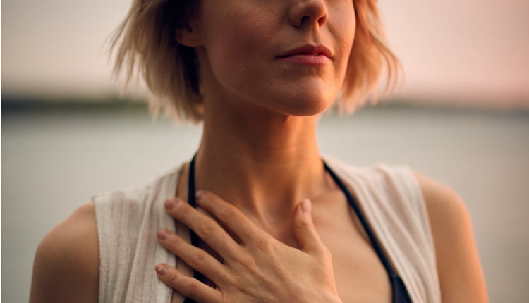 woman with hand on chest