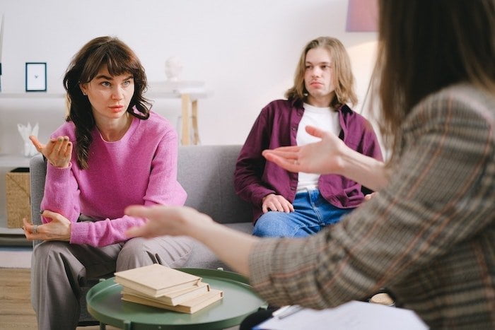 Three people talking during intervention for addiction