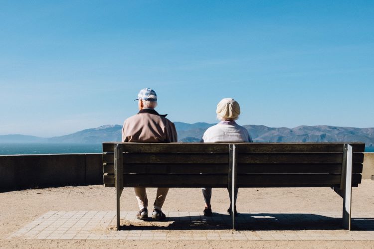 An elderly couple on a bench