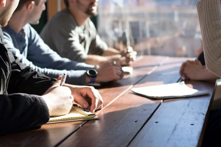 Group of patients taking notes together at a drug and alcohol rehab in Devon