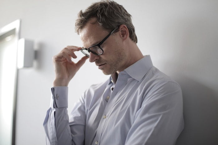 Man adjusting his glasses at a drug and alcohol rehab centre in Essex