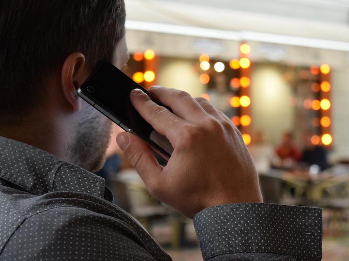 Man talking on a phone at a drug and alcohol rehab clinic in Derbyshire