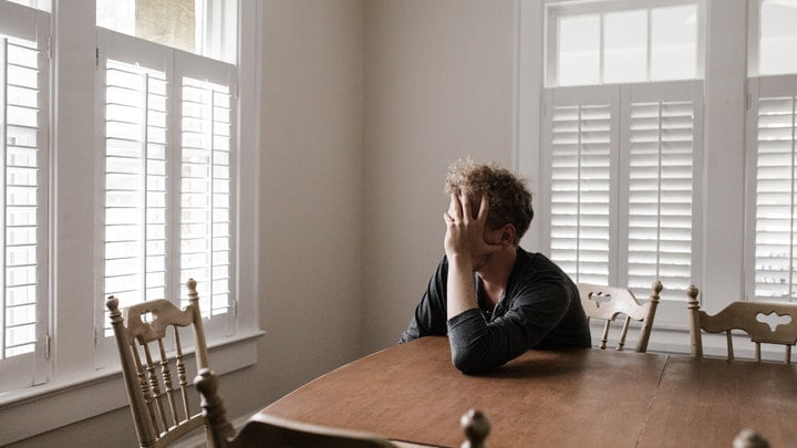 Older man holding his face at a drug and alcohol rehab in Doncaster