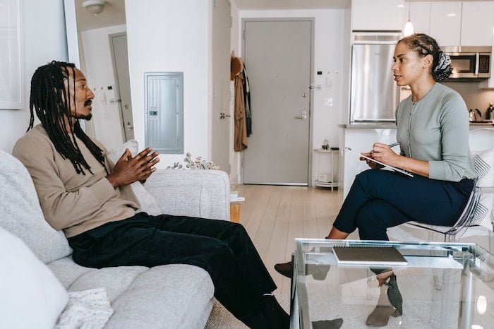 Patient sat on a sofa talking to a therapist at a drug and alcohol rehab in Doncaster