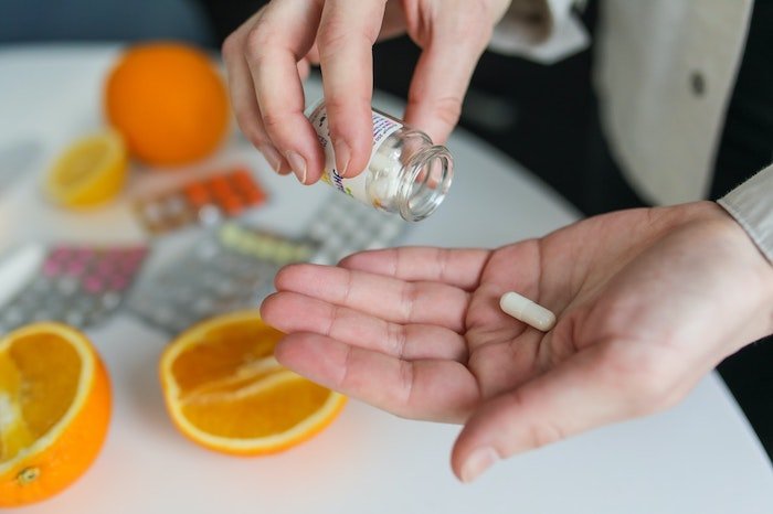 Patient taking a pill at a drug and alcohol rehab clinic in Gloucestershire