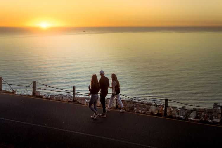 A group of people walking by sea