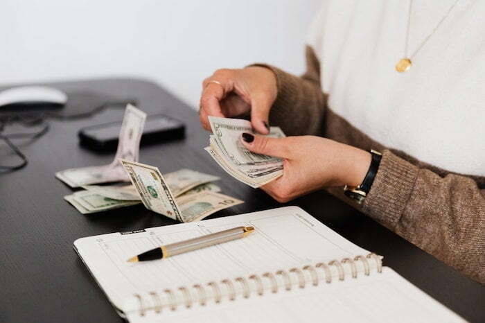 Person counting out money at a drug and alcohol rehab in Dorset