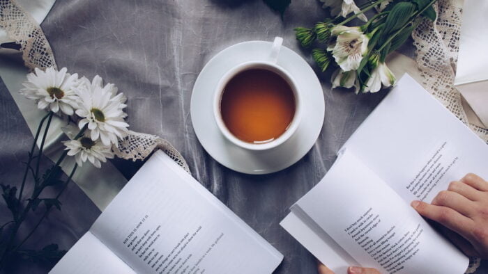 Person drinking tea and reading at a drug and alcohol rehab centre in Devon