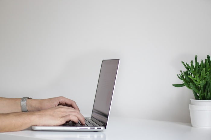 Person taking notes on a laptop at a drug and alcohol rehab clinic in Hampshire