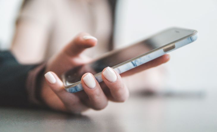 Person typing on a phone at a drug and alcohol rehab centre in Hereford