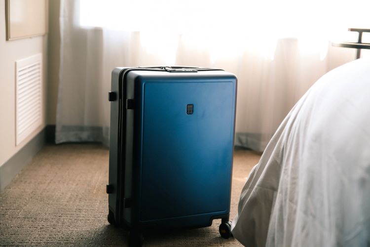 A suitcase by a bed at drug and alcohol rehab