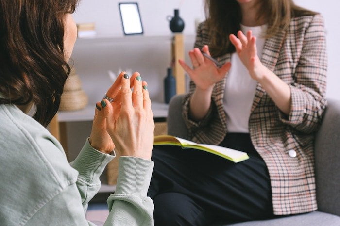 Therapist and patient talking together and taking notes at a drug and alcohol rehab in Hampshire