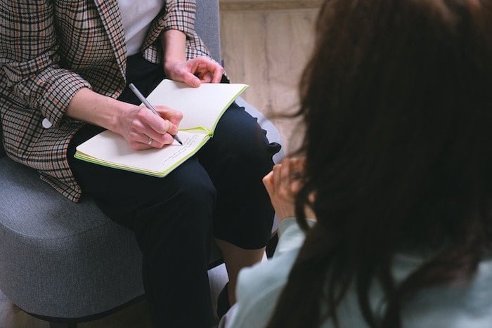 Therapist taking notes in front of a patient at a drug and alcohol rehab in Dorset