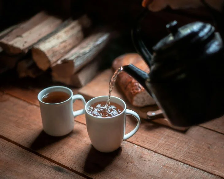 Two cups of tea being poured at a drug and alcohol intervention