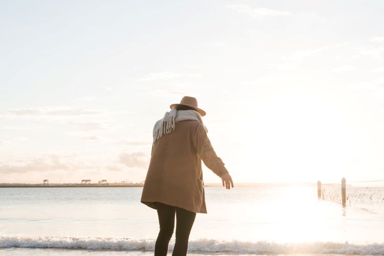 person walking on beach