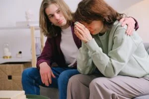 Woman crying and a man comforting her