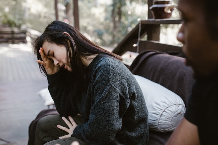 Woman crying on a bench