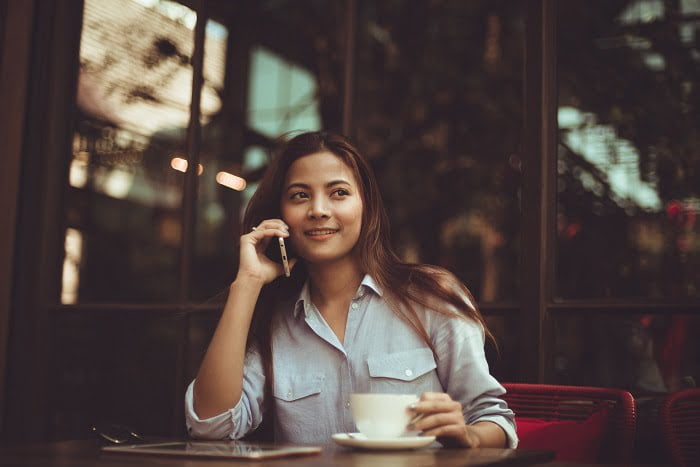 Woman speaking on a phone at a drug and alcohol rehab centre in Dorset