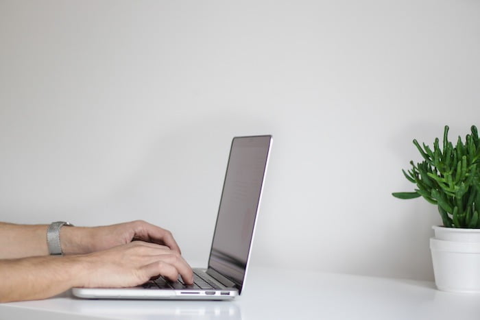 Someone typing on their laptop at drug and alcohol rehab in Belfast