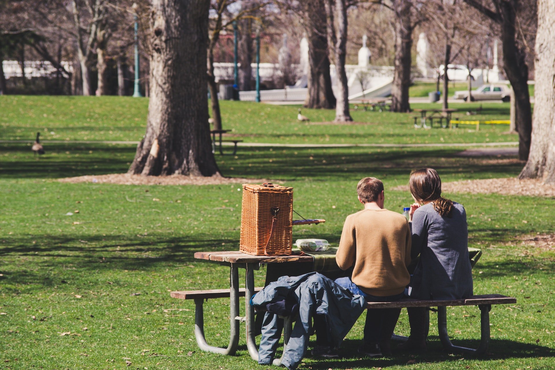 View of a couple sitting on a picnic table