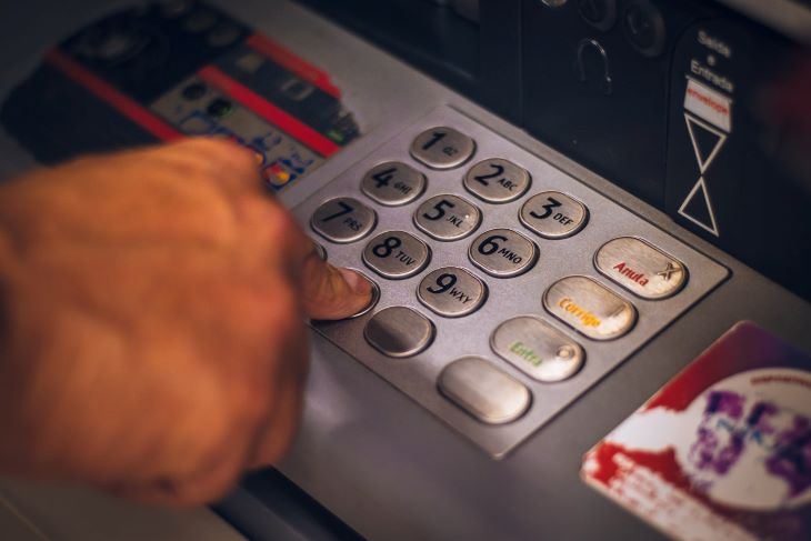 A person accessing an ATM