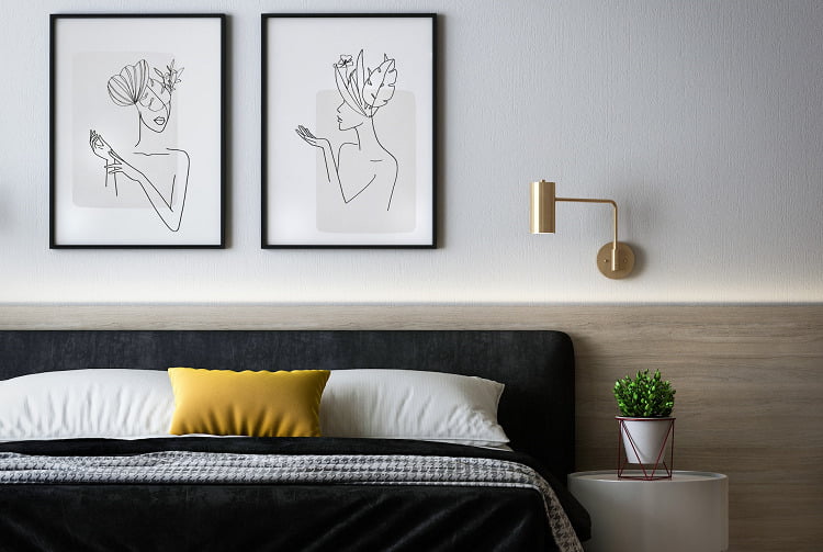 A bedroom with art above the bed