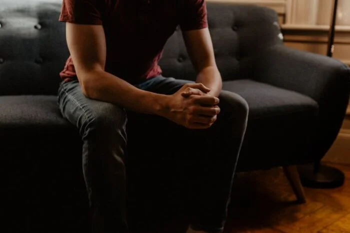 A man sitting down in a music therapy session for drug addiction