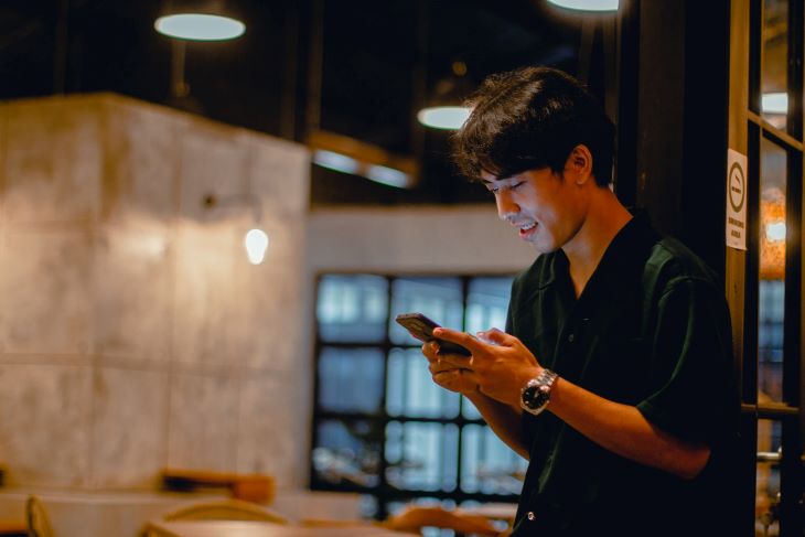 Man looking at phone, smiling