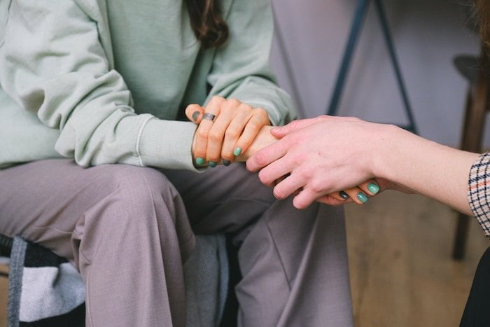 Two people holding hands at a drug and alcohol rehab in Hemel Hempstead