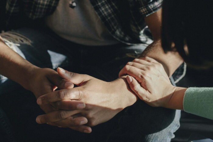 A woman holding the arm of a man