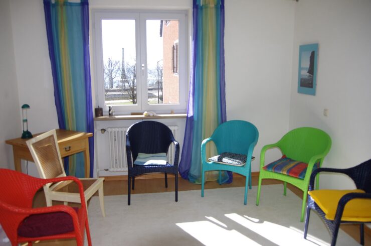 A circle of colourful chairs at rehab