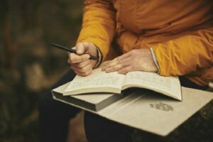 A woman writing in a diary