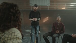 A man speaking to a group about addiction at rehab in Bournemouth