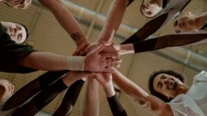 People putting their hands in the middle together at a drug & alcohol rehab centre