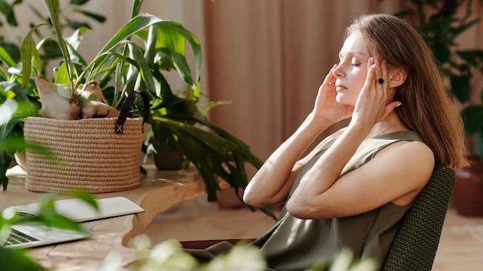 A woman looking stressed as she checks into a luxury rehab for addiction