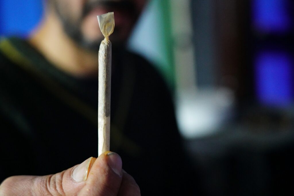 man holding cannabis spliff