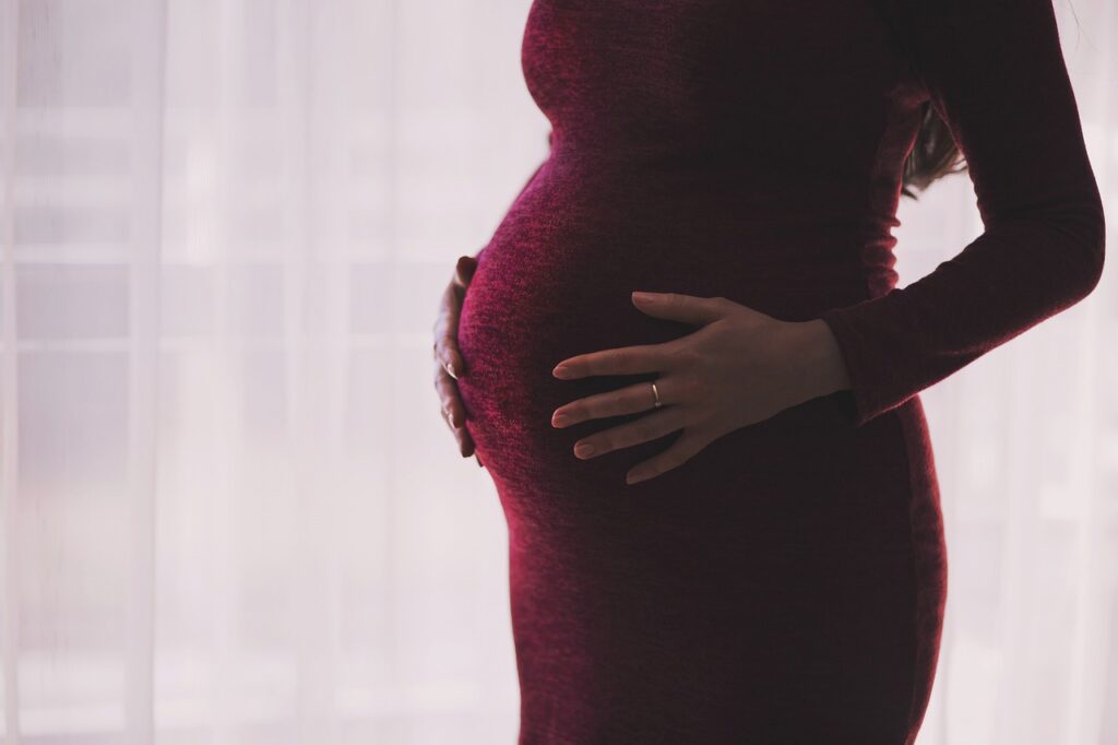 Pregnant woman holding her tummy