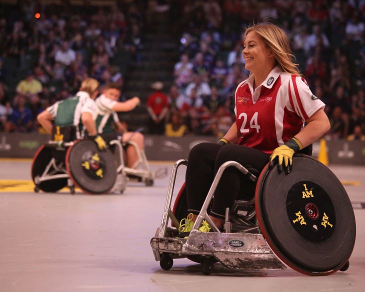 A disabled athlete smiling in her wheelchair during a game