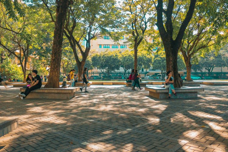 People sitting on benches at a university campus