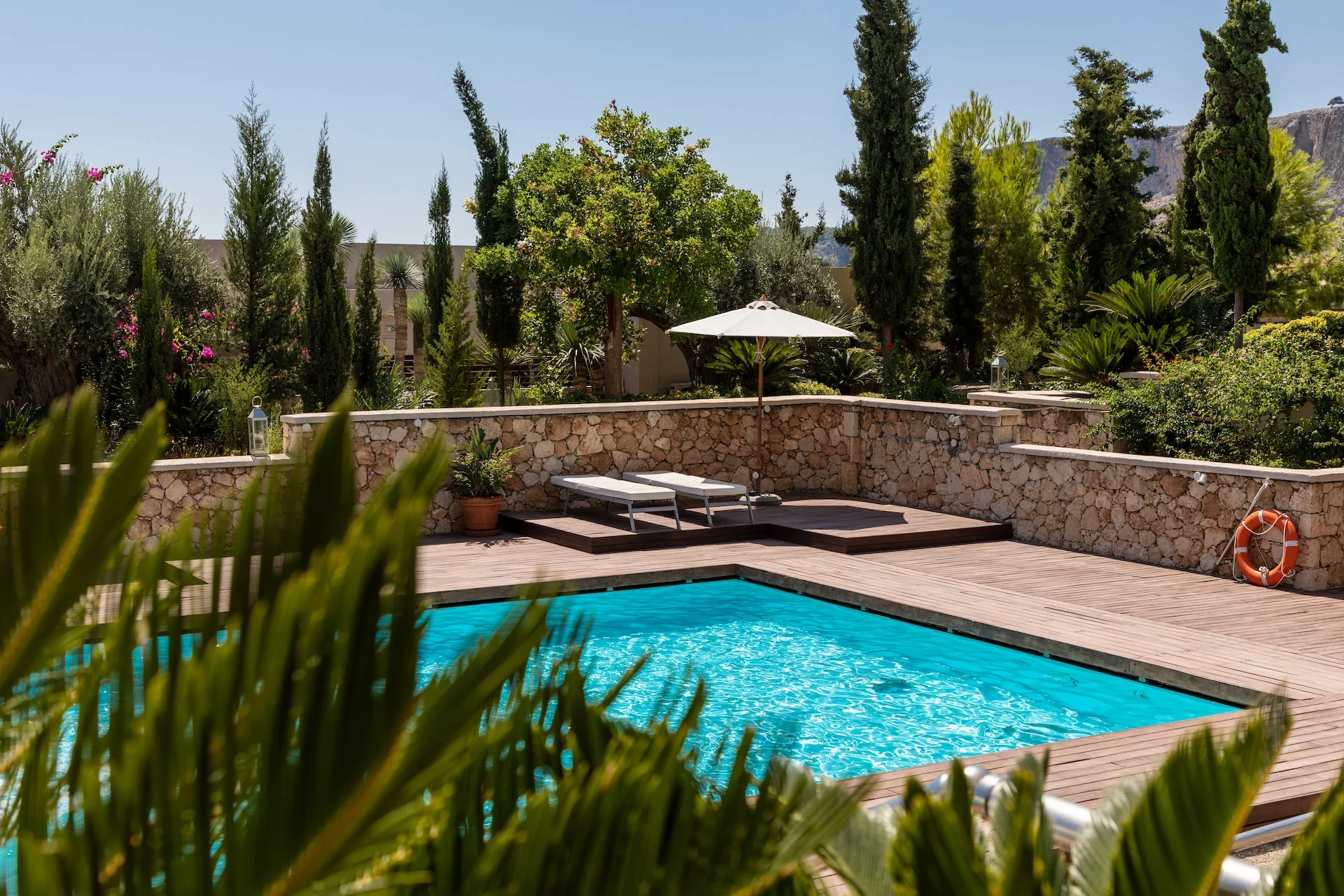 A luxury and empty outdoor swimming pool in the sun