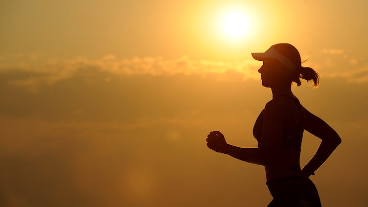 silhouette of runner in sunset