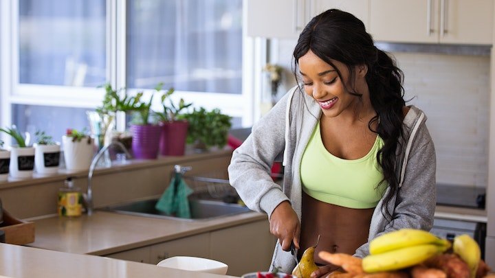 A woman cutting up fruit