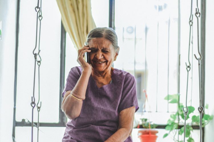 A woman talking on a mobile phone and grinning