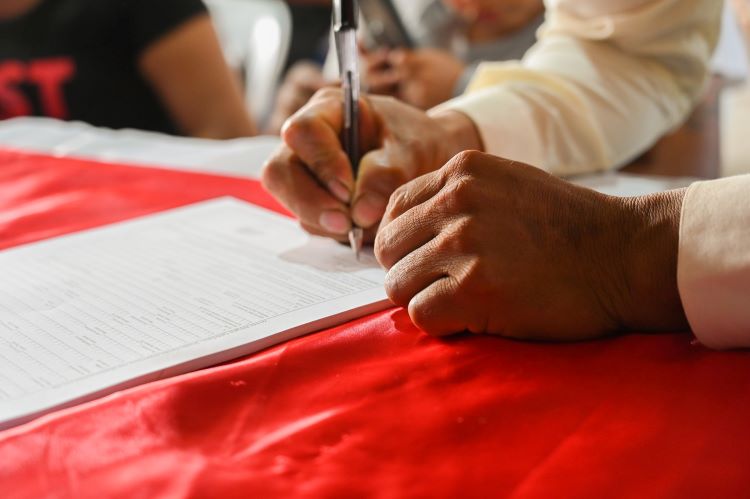 A man signing documents