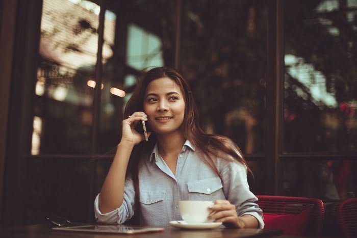 Woman talking on a phone after dual diagnosis treatment