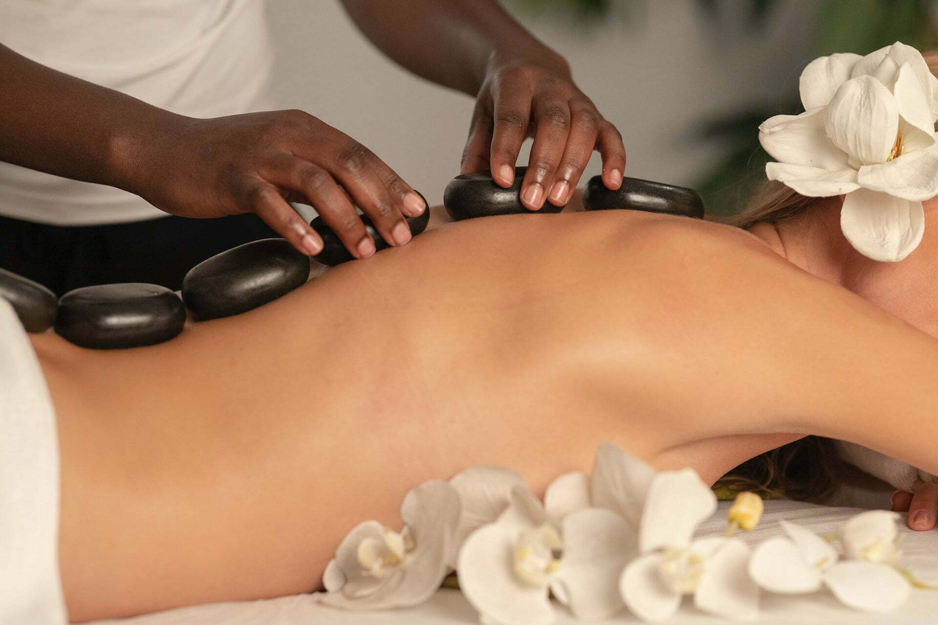 Person having a hot stone massage during holistic therapy for addiction